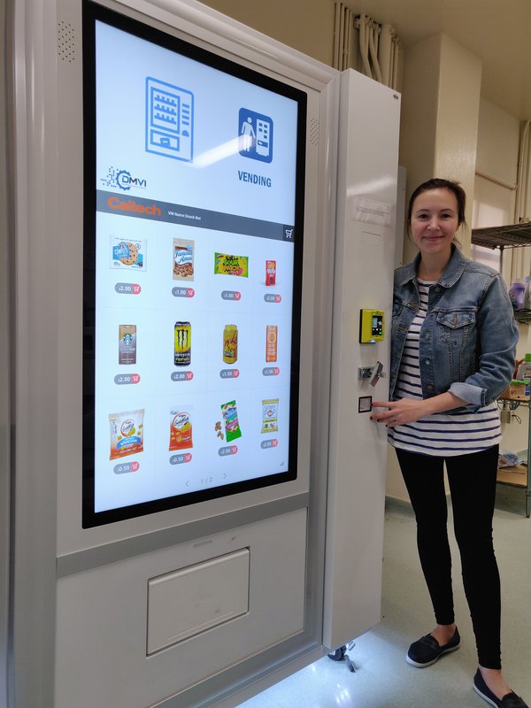 Anastasia with the customizable vending machine she installed on Caltech's campus.Anastasia with the customizable vending machine she installed on Caltech's campus.